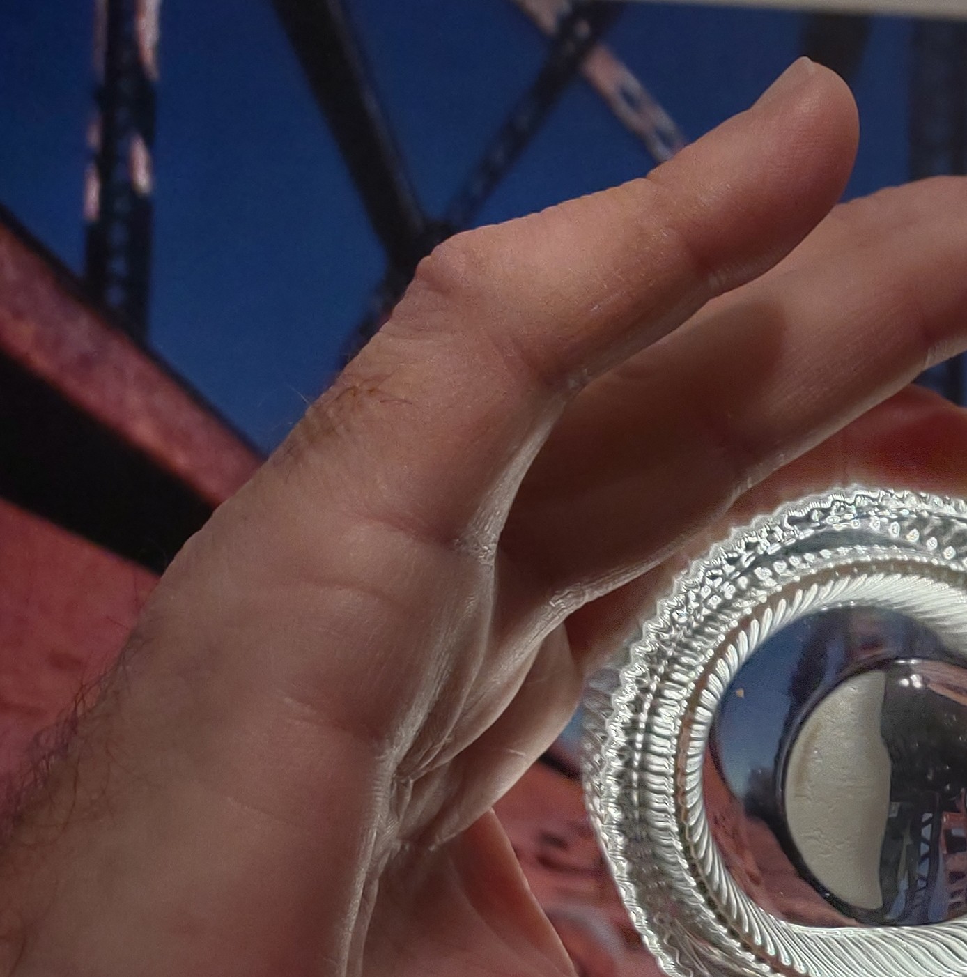 Image through a glass in a man's hand